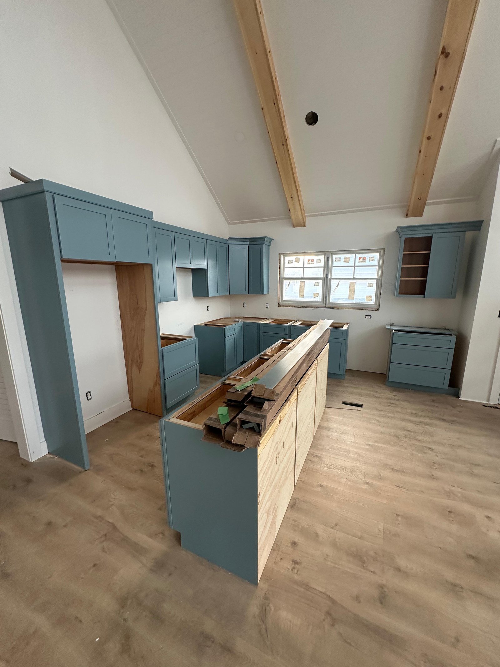 Blue kitchen cabinetry and island during installation